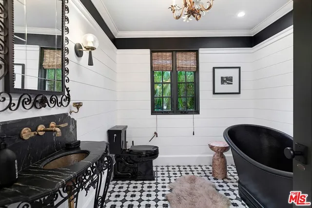 a room with a sink and glass door