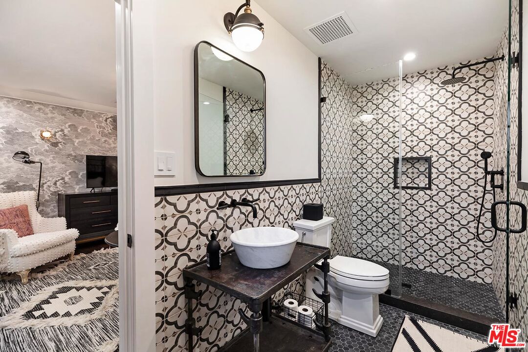 4416 Arcola Avenue Toluca Lake, CA 91602 - Photo 31 of 46 a bathroom with a toilet sink and mirror