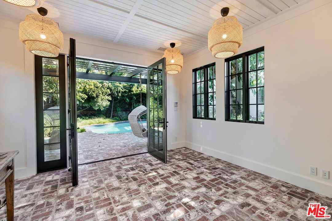4416 Arcola Avenue Toluca Lake, CA 91602 - Photo 43 of 46 a view of a hallway to a livingroom with furniture and floor to ceiling window