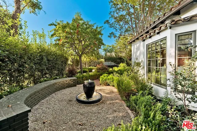 a view of an house with backyard space and garden