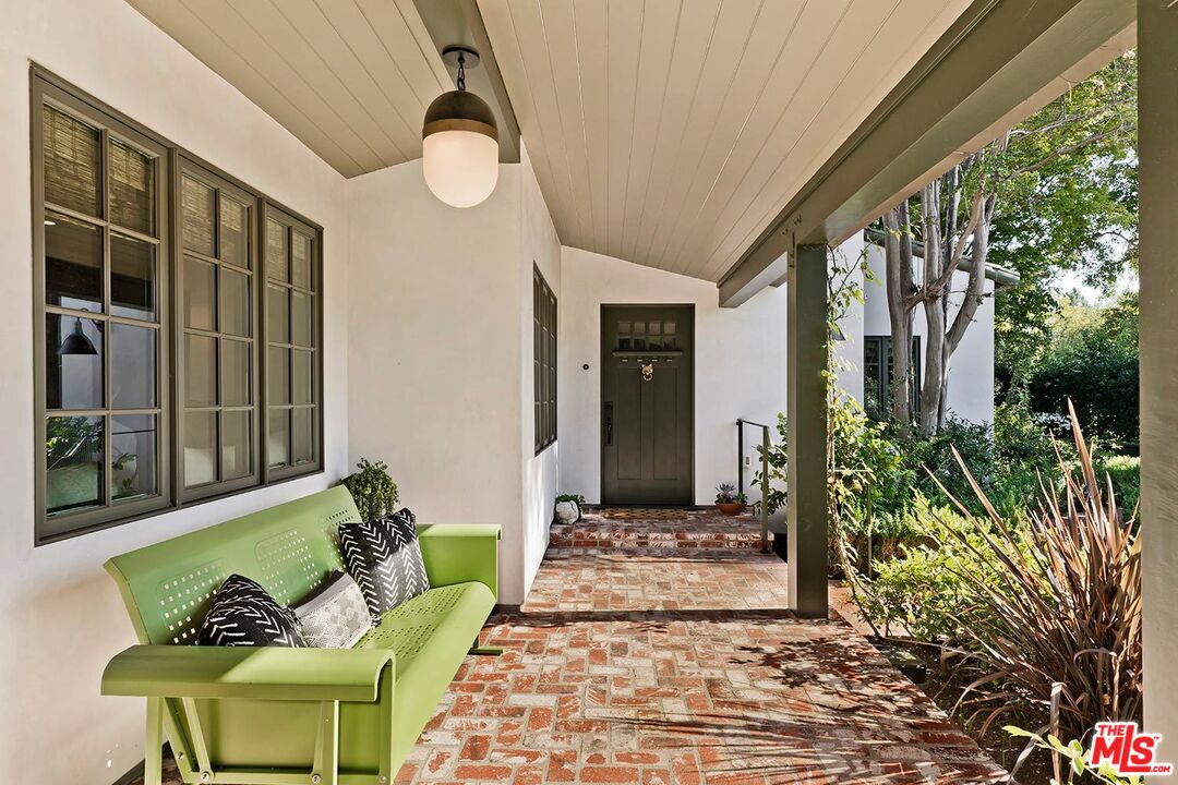 4416 Arcola Avenue Toluca Lake, CA 91602 - Photo 6 of 46 a front view of a house with outdoor seating and plants