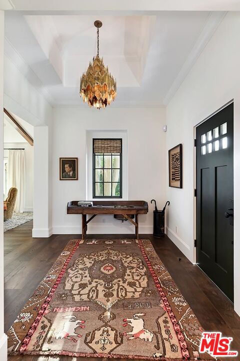 4416 Arcola Avenue Toluca Lake, CA 91602 - Photo 7 of 46 a bedroom with a bed and a chandelier