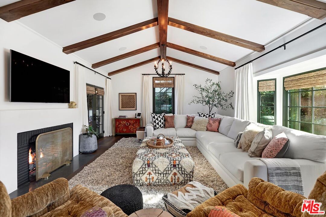 4416 Arcola Avenue Toluca Lake, CA 91602 - Photo 8 of 46 a living room with furniture a fireplace and a flat screen tv