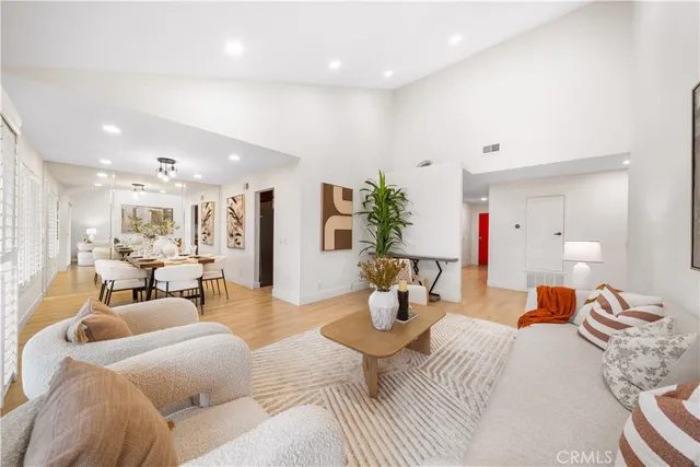 a spacious bedroom with a bed and large windows