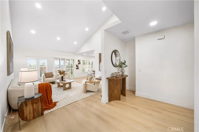 a bedroom with a bed and potted plant with chair