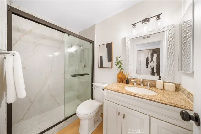 a bathroom with a shower and toilet