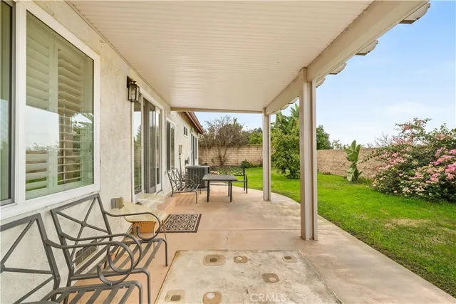 a front view of house with yard and trees around