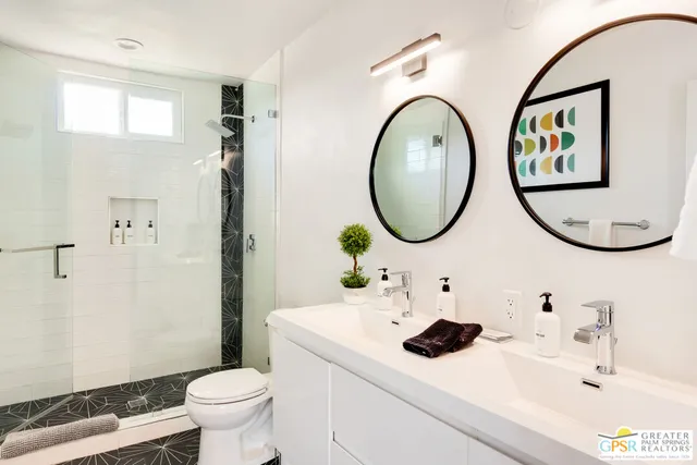 a bathroom with a toilet a sink and a mirror