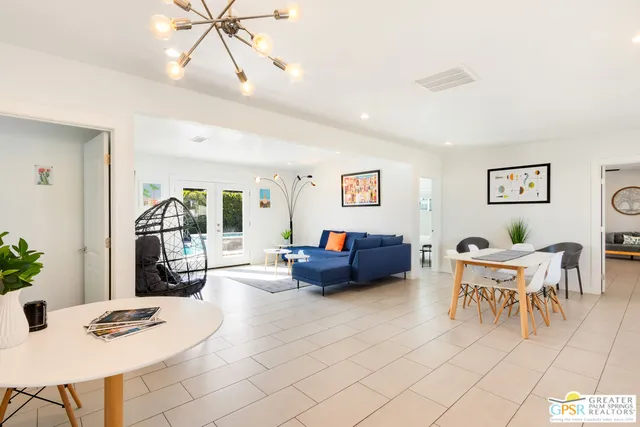 a living room with furniture and a chandelier