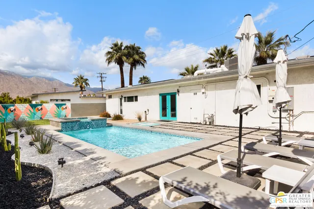 a view of a white house with a patio