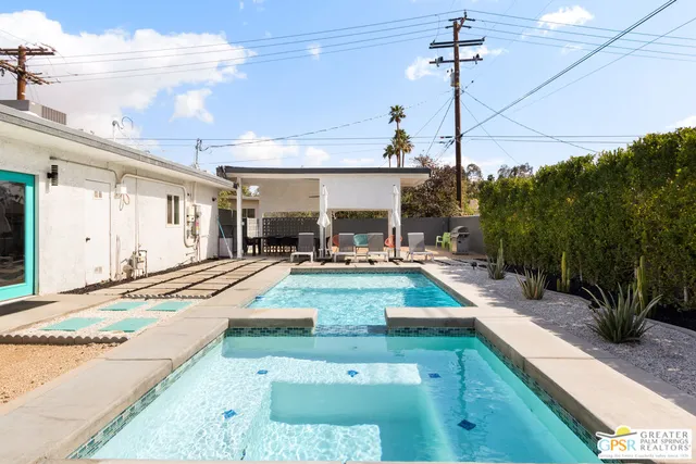 a view of a swimming pool with potted plants