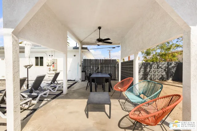 a living room with furniture a fireplace and a chandelier