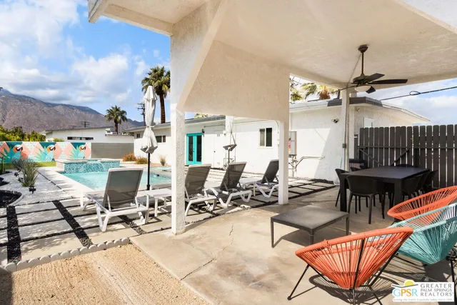 a building outdoor space with patio furniture and potted plants