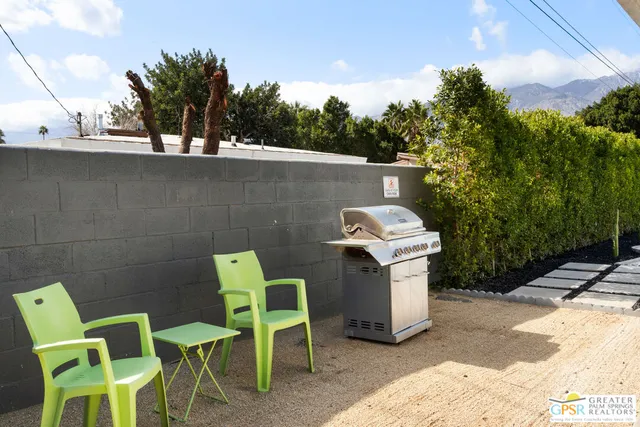 a view of a chairs and table in a backyard