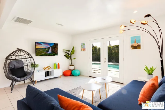 a living room with furniture and a potted plant