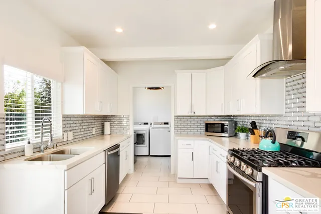 a kitchen with a stove a sink and a refrigerator