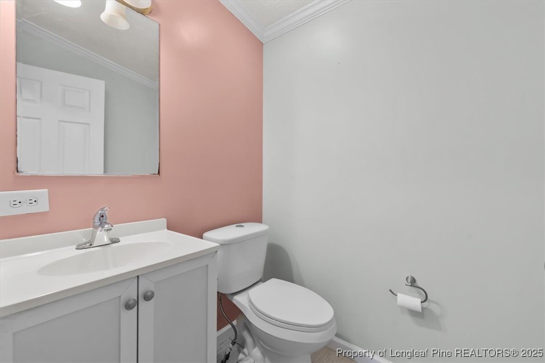 11891 Aberdeen Road Aberdeen, NC 28315 - Photo 21 of 35 a bathroom with a toilet a sink and mirror