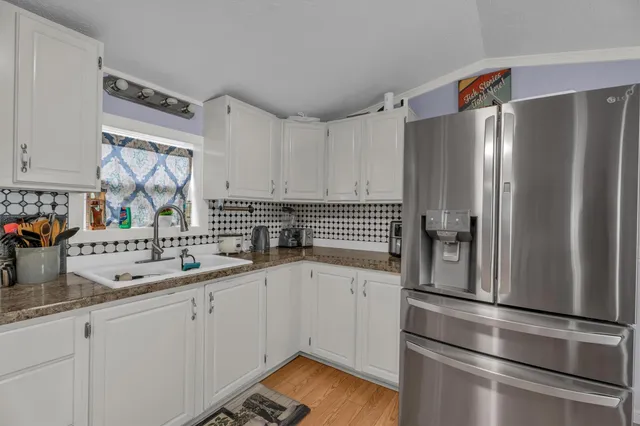 a kitchen with a sink appliances and cabinets