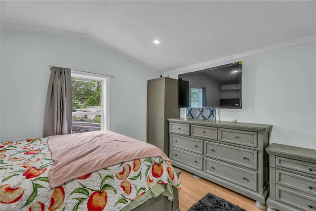 a bedroom with a bed and a dresser in it