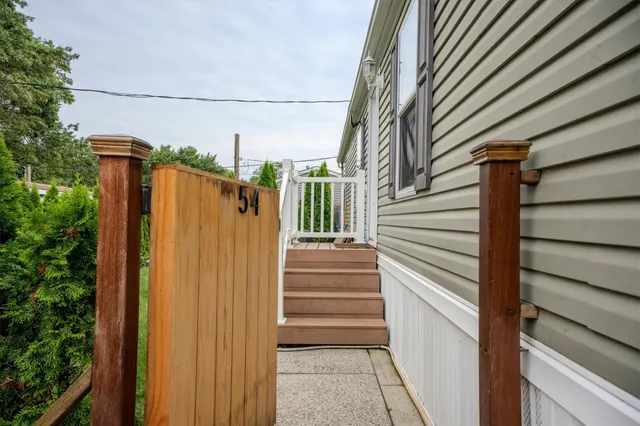 a view of a house with a door and wooden walls