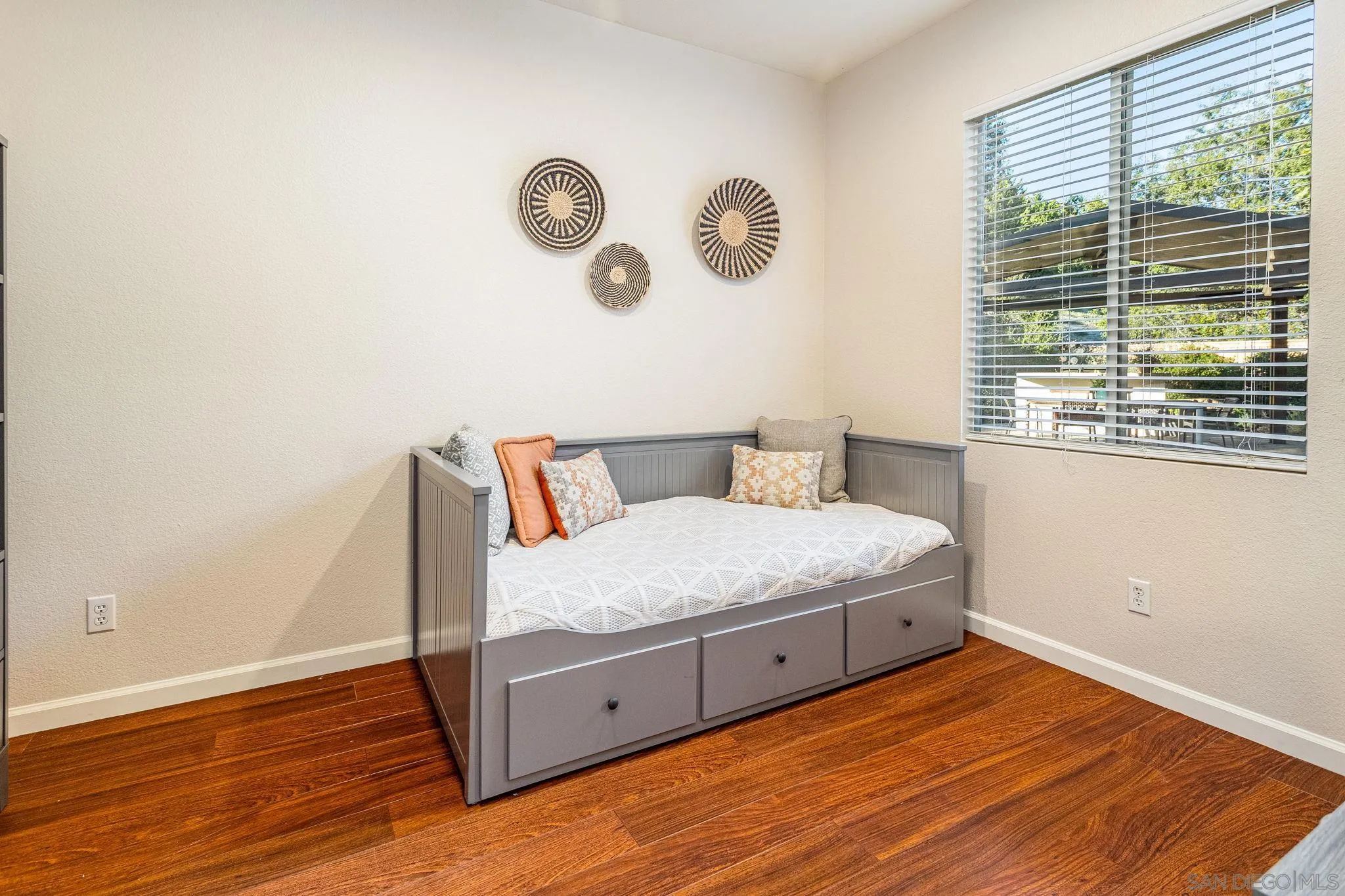 5462 Senegal Street Oceanside, CA 92057 - Photo 14 of 47 a bedroom with a bed and wooden floor