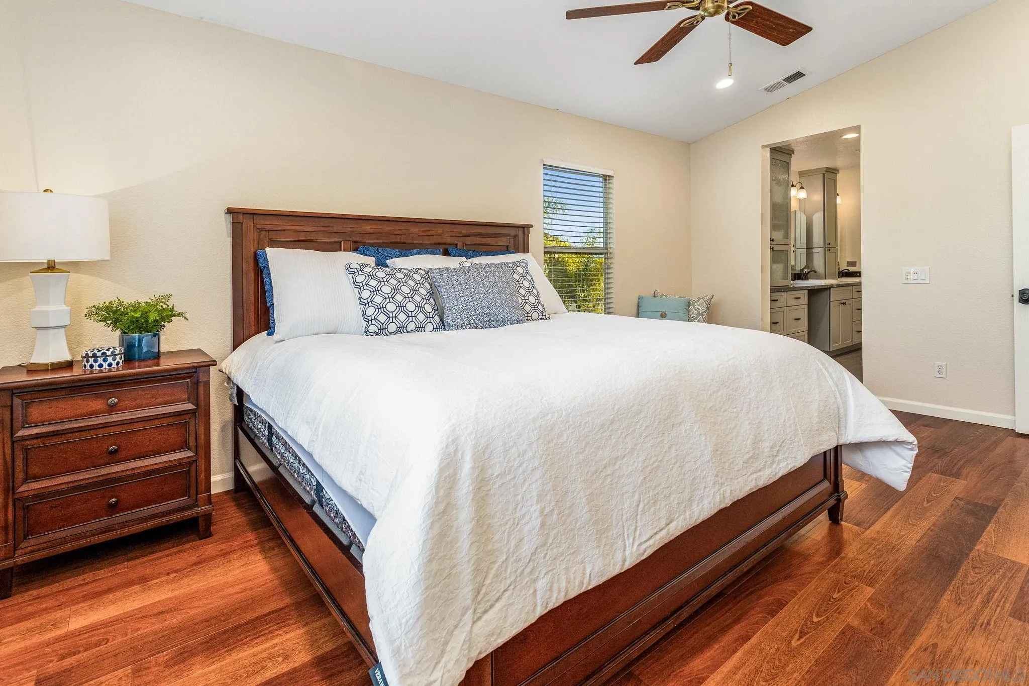 5462 Senegal Street Oceanside, CA 92057 - Photo 18 of 47 a bedroom with a bed and wooden floor