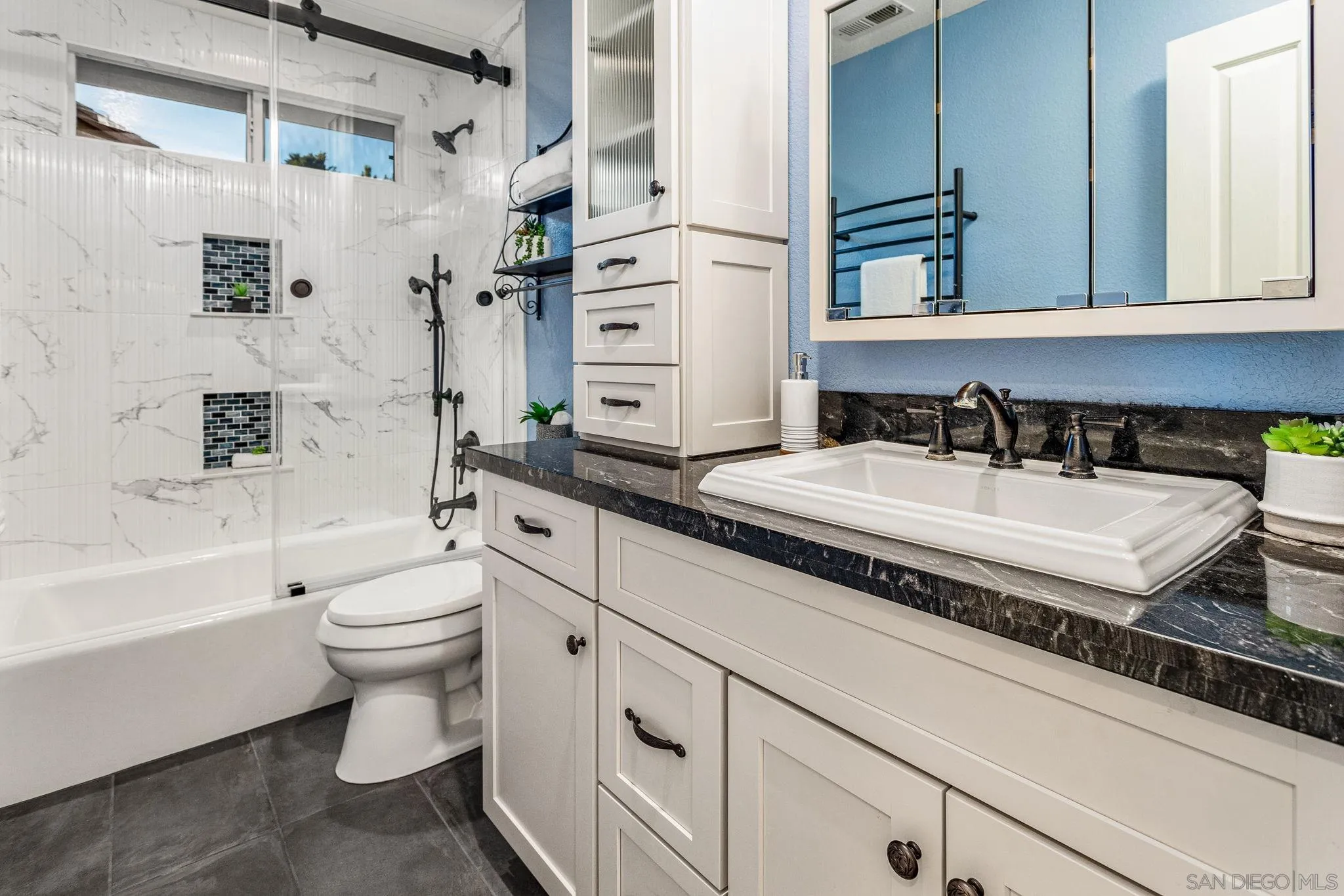 5462 Senegal Street Oceanside, CA 92057 - Photo 23 of 47 a bathroom with a granite countertop sink toilet and shower
