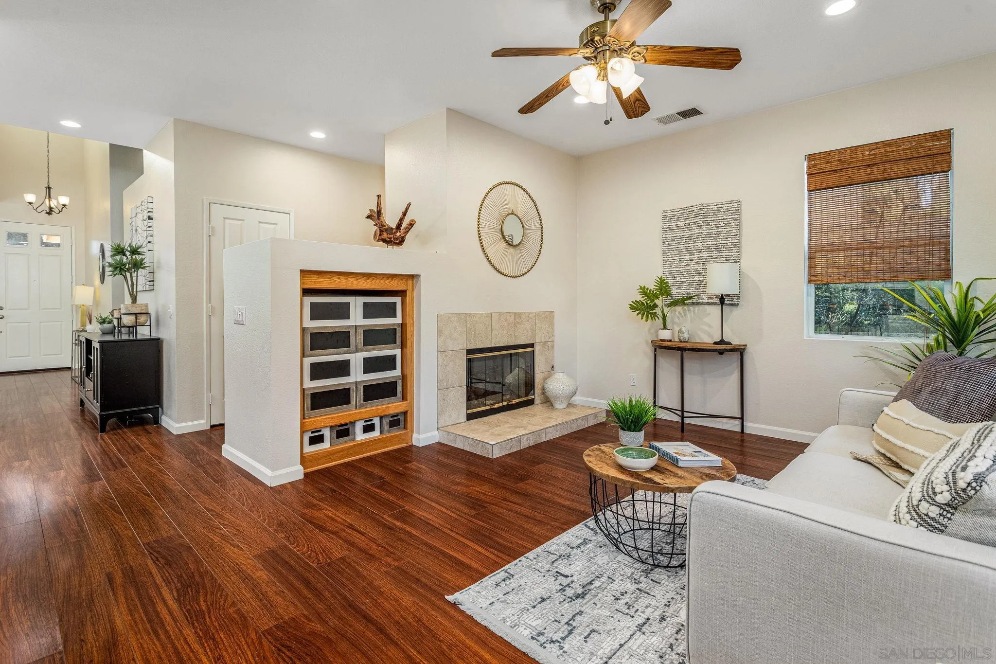 5462 Senegal Street Oceanside, CA 92057 - Photo 8 of 47 a living room with furniture a fireplace and a window