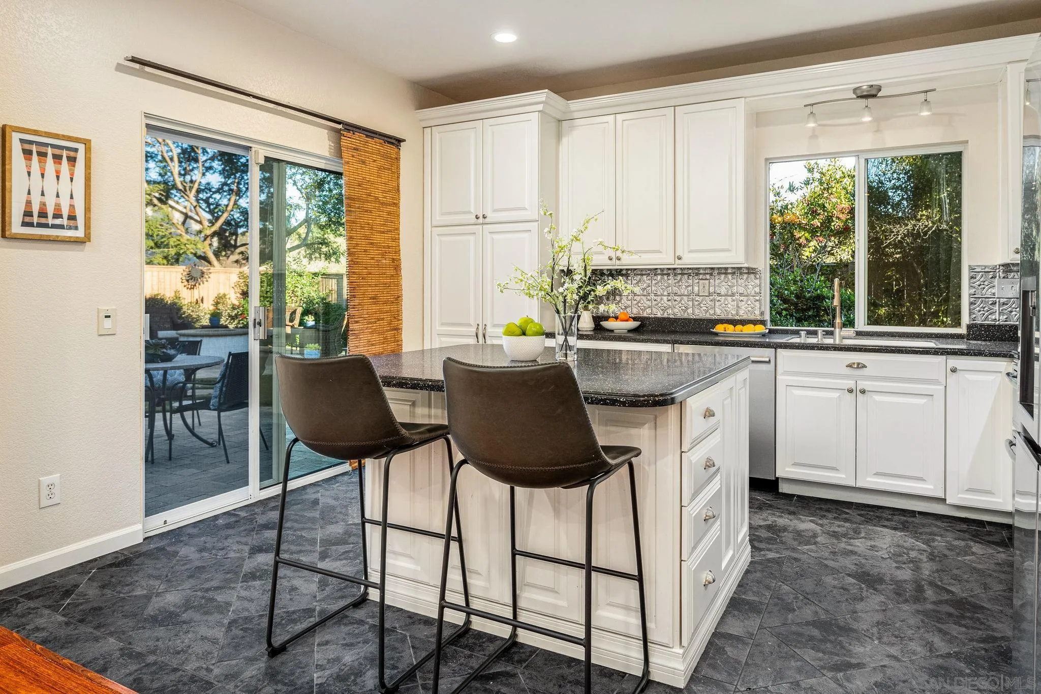 5462 Senegal Street Oceanside, CA 92057 - Photo 10 of 47 a kitchen with a stove a sink and chairs