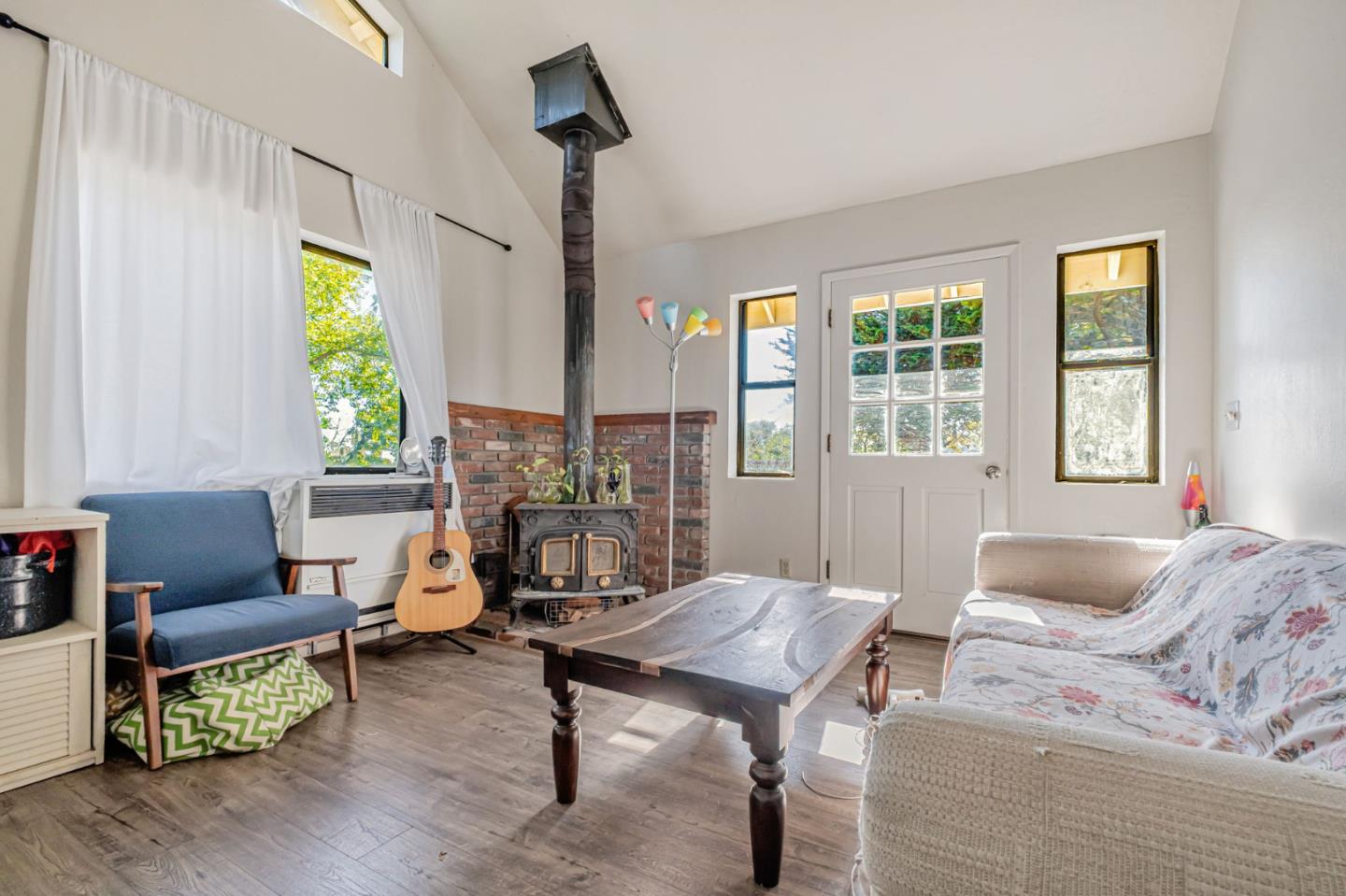 222 Highview Drive Santa Cruz, CA 95060 - Photo 24 of 29 a living room with furniture a fireplace and a table