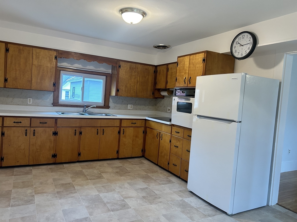 a kitchen with cabinets and window