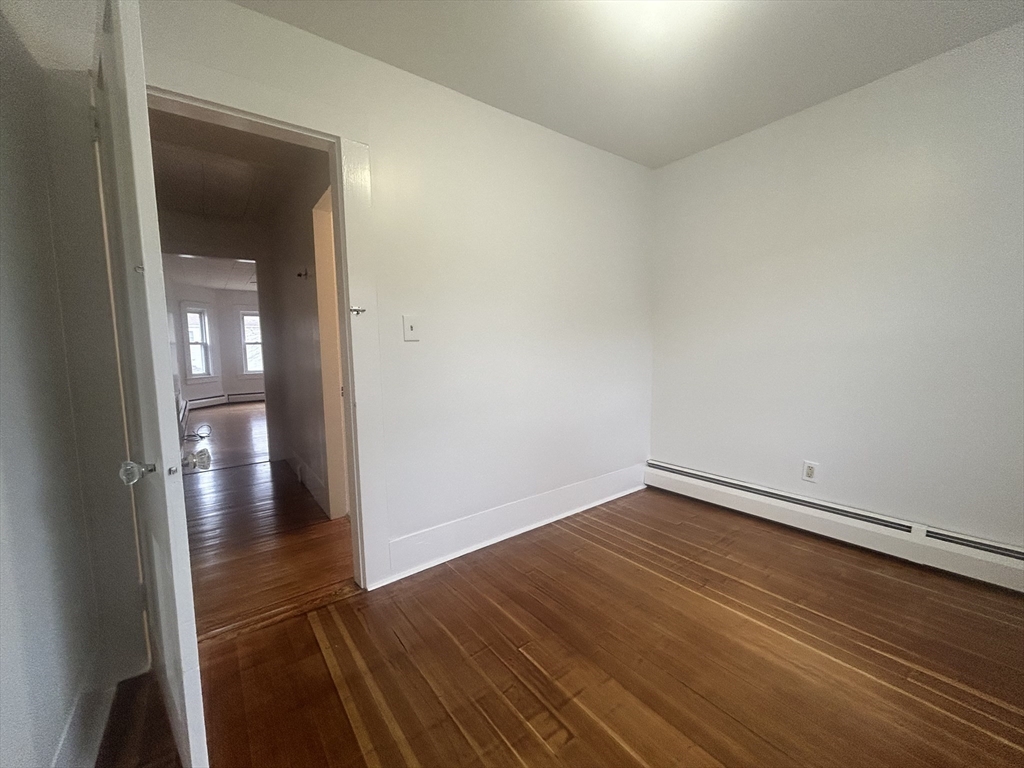 17 Lincoln Street, Unit 2 Greenfield, MA 01301 - Photo 17 of 26 a view of a hallway with wooden floor