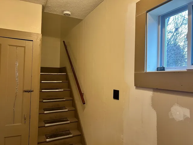 a view of entryway with wooden floor and windows