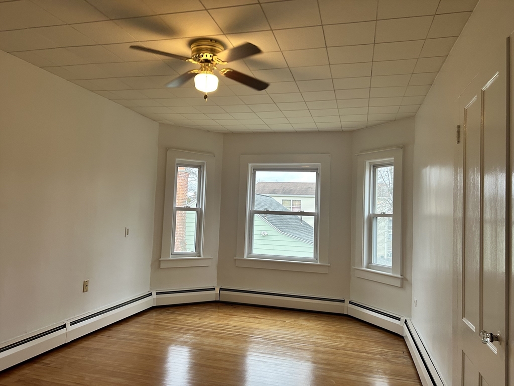 17 Lincoln Street, Unit 2 Greenfield, MA 01301 - Photo 5 of 26 a view of an empty room with window and wooden floor