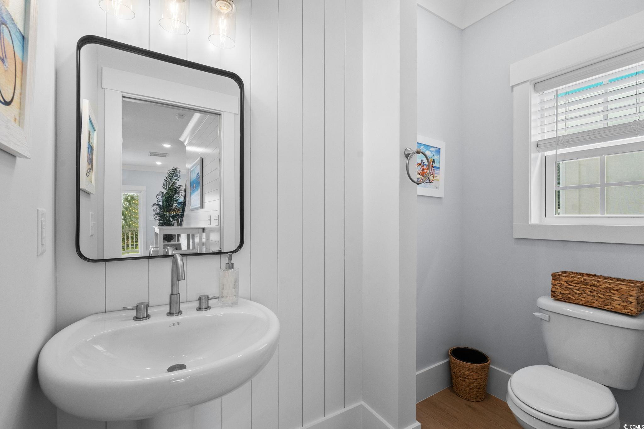 2312 Seaseeker Lane Myrtle Beach, SC 29577 - Photo 11 of 37 Bathroom featuring a sink and wood finished floors