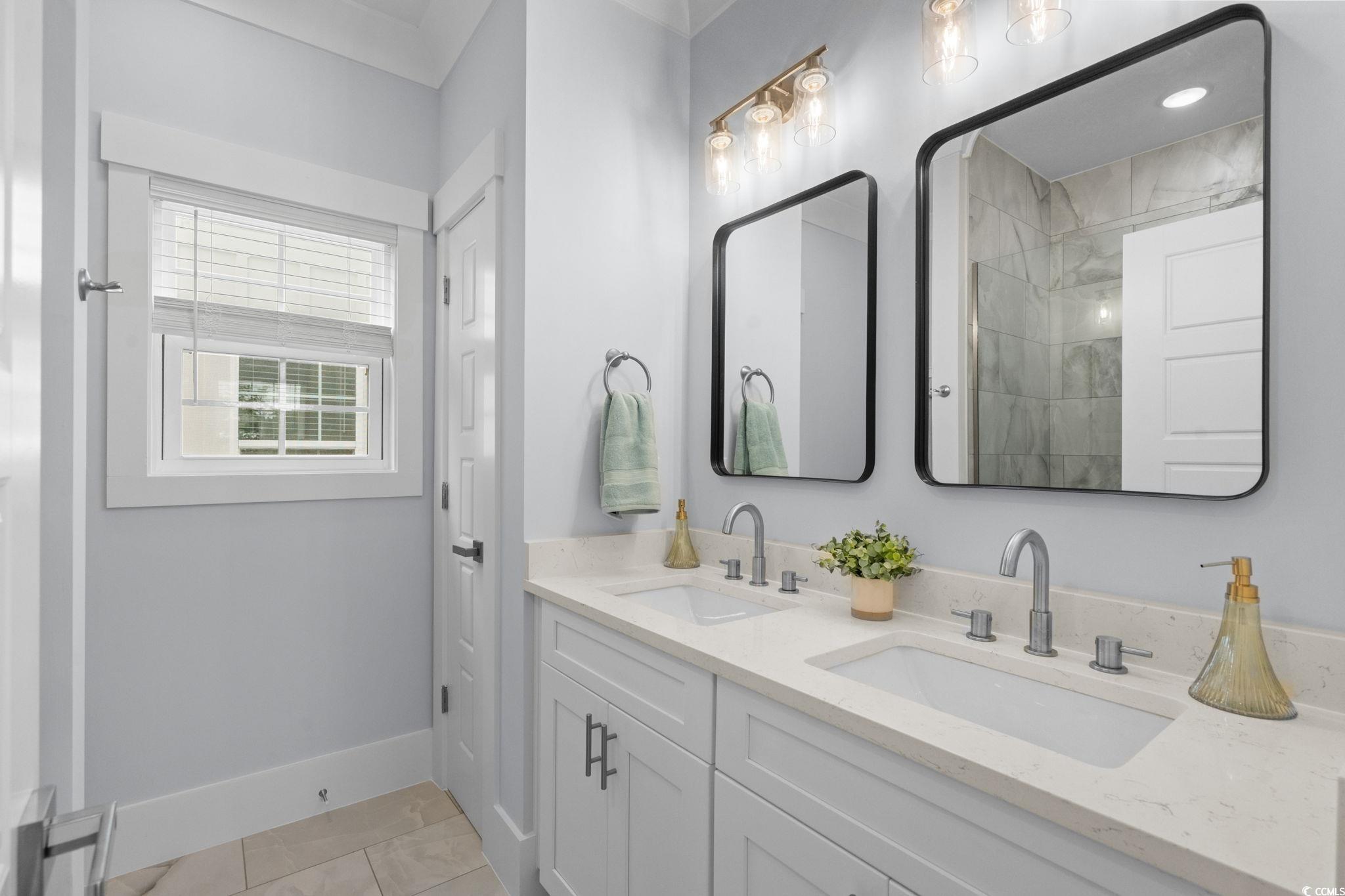 2312 Seaseeker Lane Myrtle Beach, SC 29577 - Photo 16 of 37 Full bathroom with double vanity and light tile patterned flooring