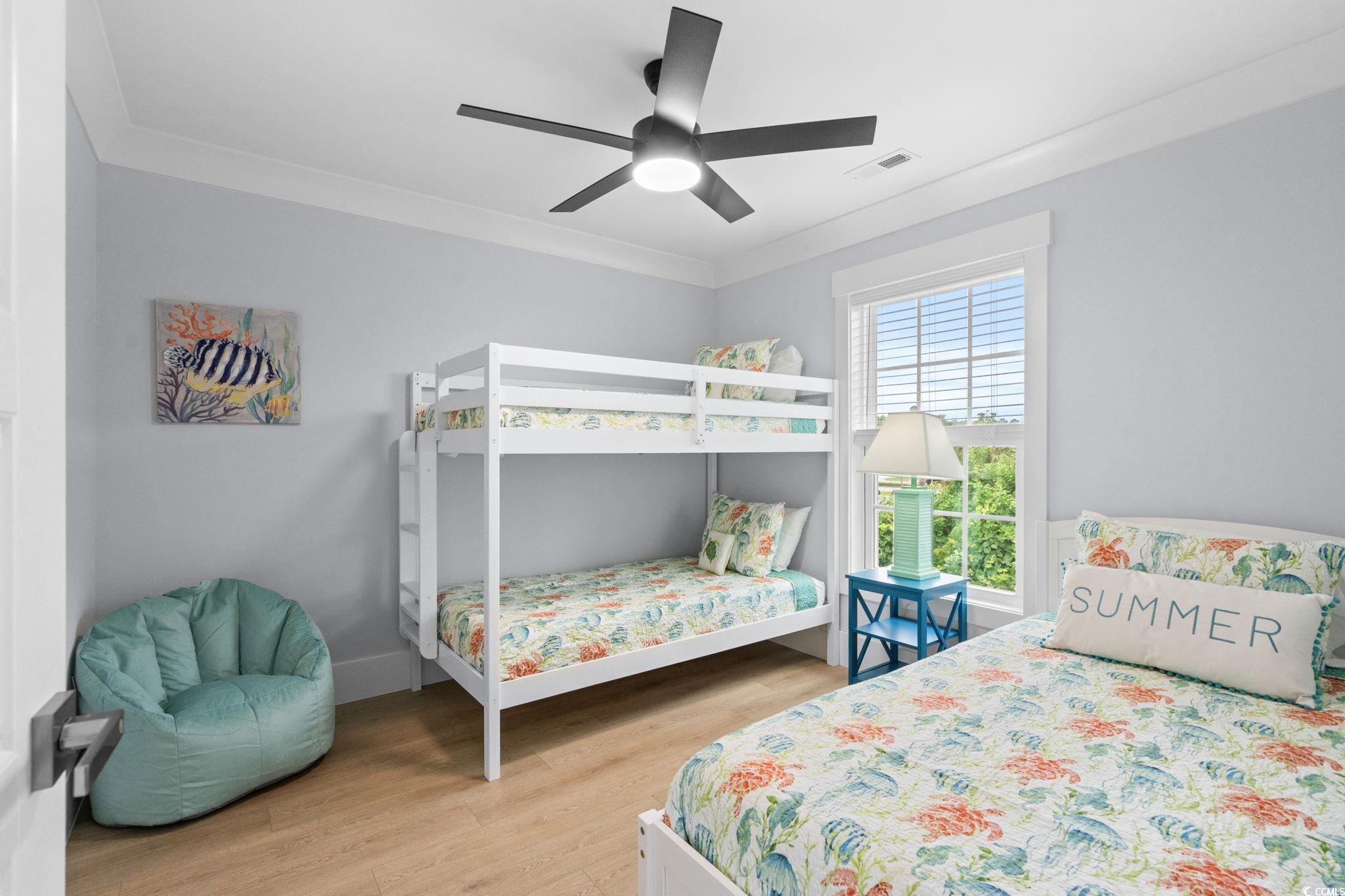 2312 Seaseeker Lane Myrtle Beach, SC 29577 - Photo 20 of 37 Bedroom with light wood-style flooring, crown molding, and ceiling fan