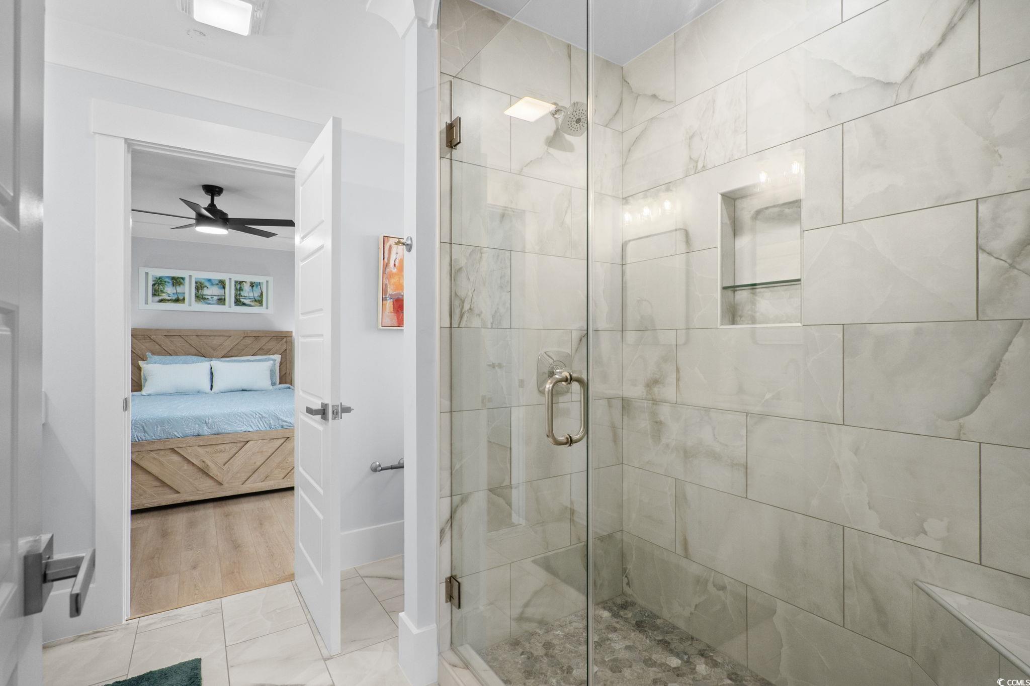 2312 Seaseeker Lane Myrtle Beach, SC 29577 - Photo 21 of 37 Full bath featuring a shower stall, ensuite bath, a ceiling fan, and light tile patterned floors