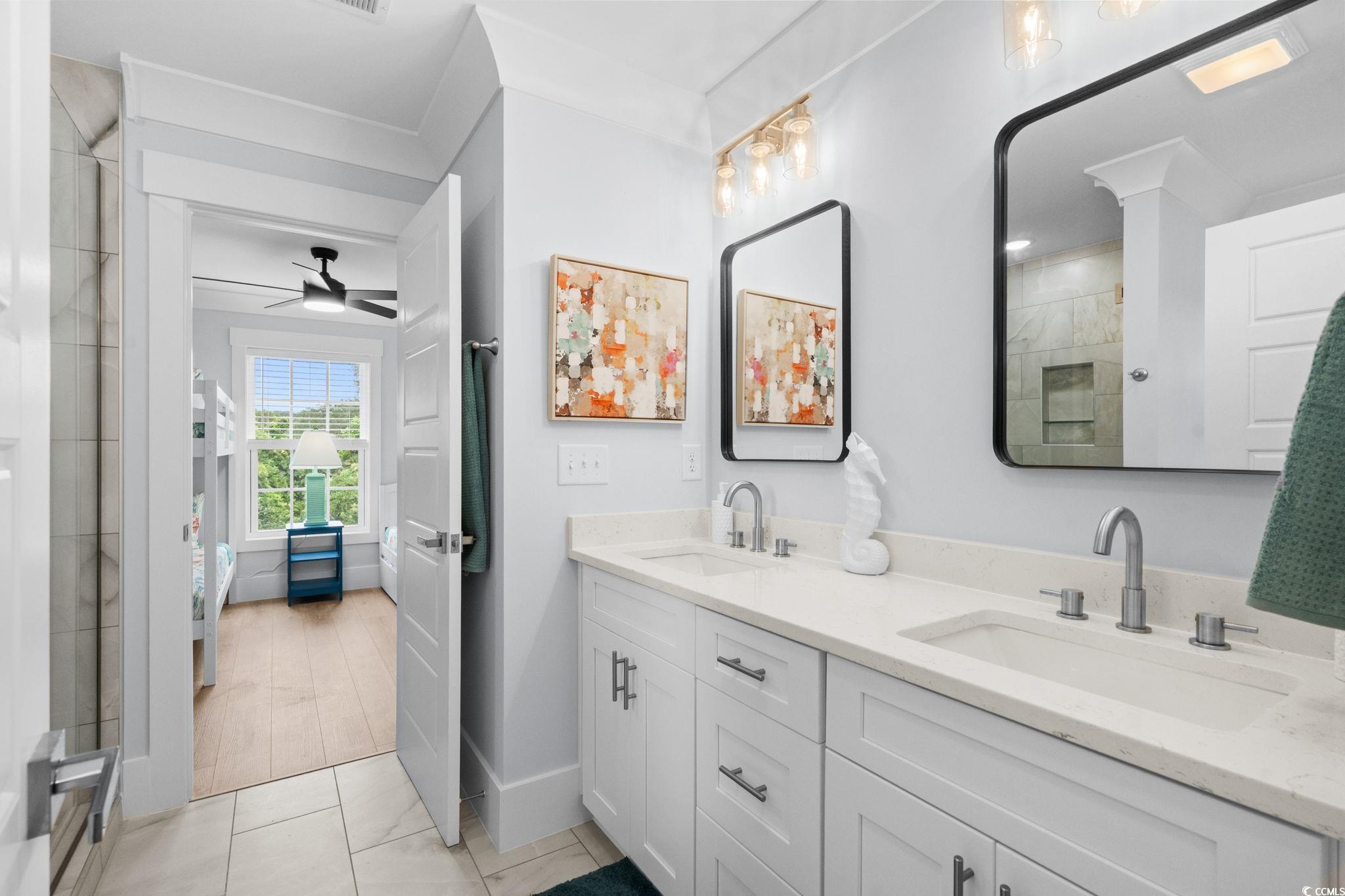 2312 Seaseeker Lane Myrtle Beach, SC 29577 - Photo 22 of 37 Ensuite bathroom with double vanity, a stall shower, light tile patterned floors, and a ceiling fan