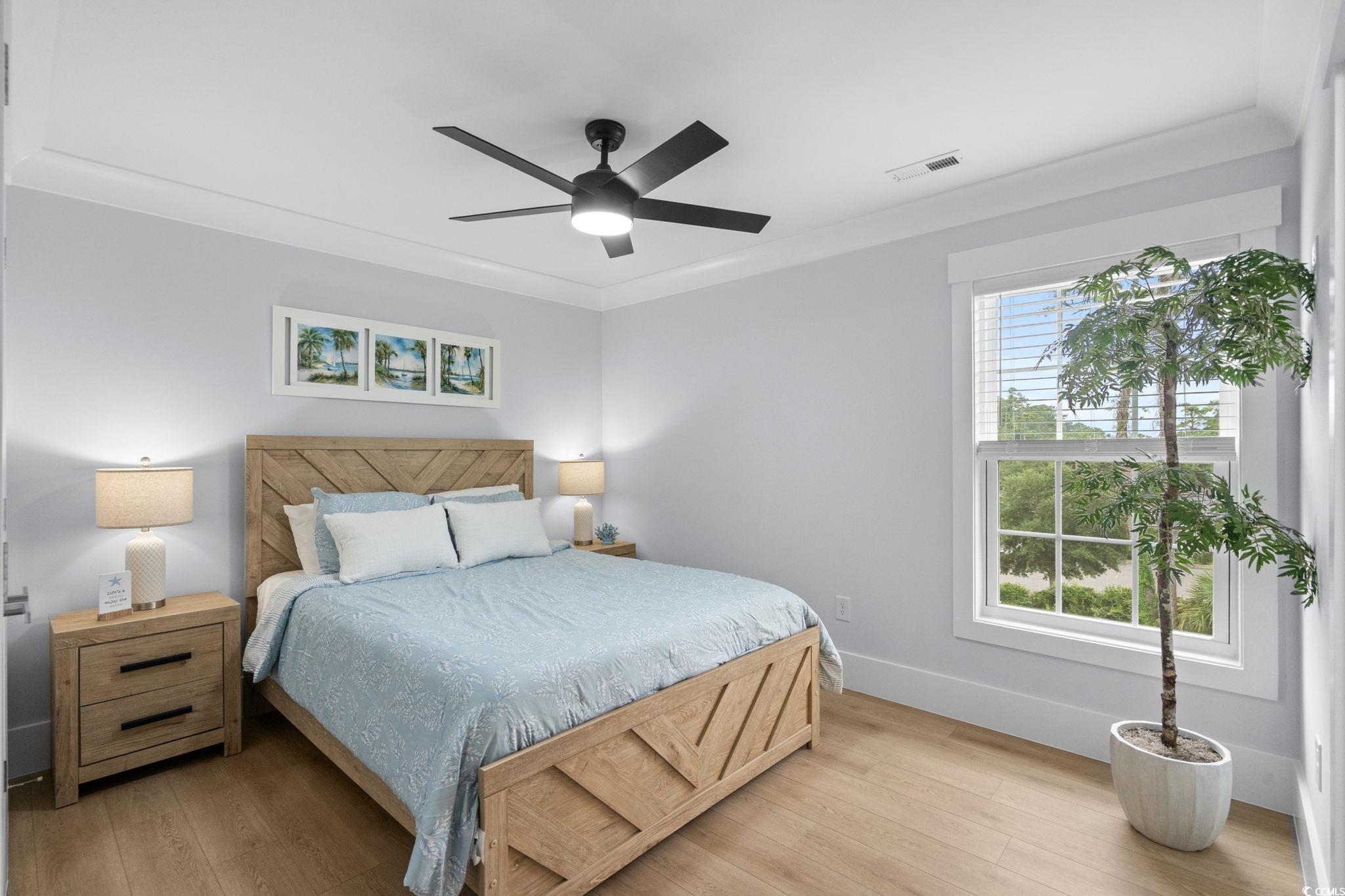 2312 Seaseeker Lane Myrtle Beach, SC 29577 - Photo 23 of 37 Bedroom featuring light wood-style floors, ceiling fan, and crown molding