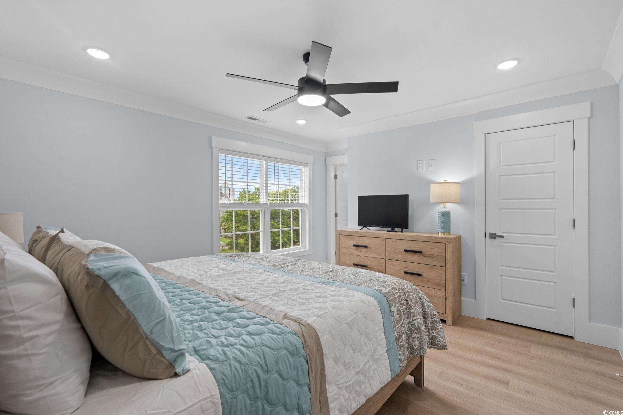 2312 Seaseeker Lane Myrtle Beach, SC 29577 - Photo 25 of 37 Bedroom with light wood-type flooring, crown molding, recessed lighting, and a ceiling fan