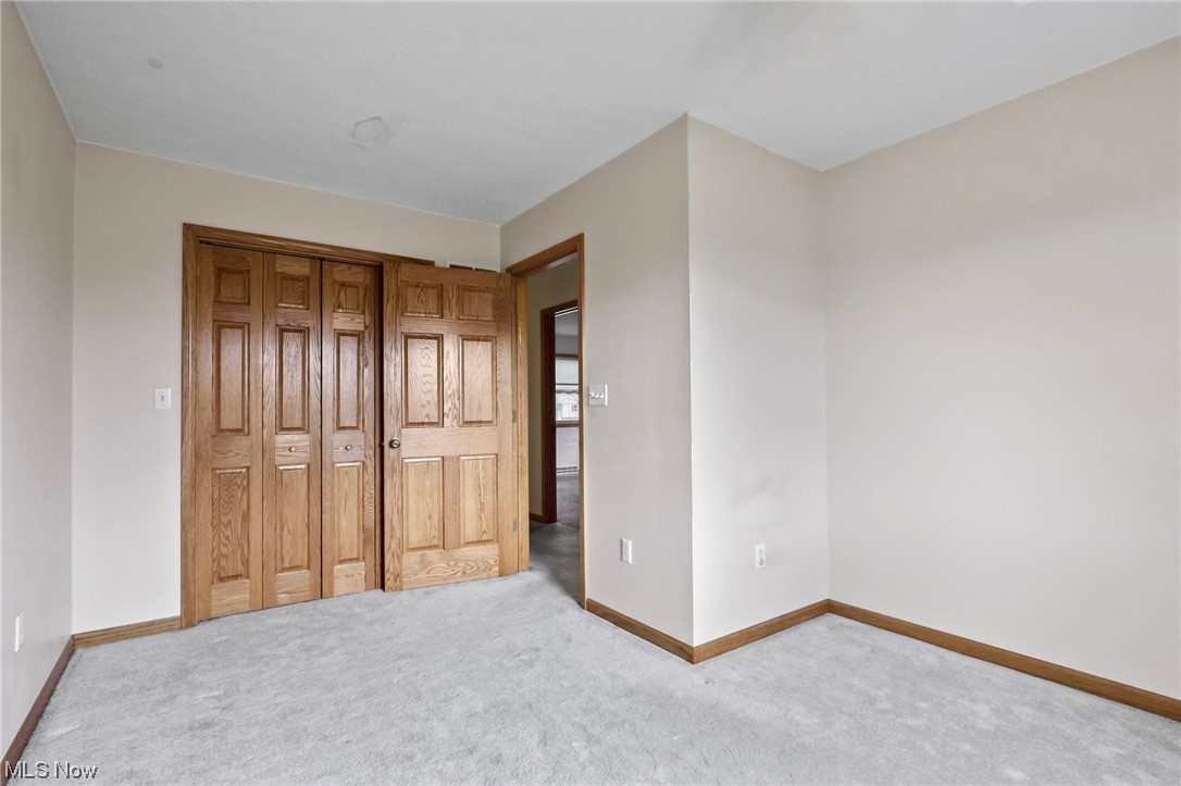 411 Adario West Road Shiloh, OH 44878 - Photo 25 of 35 Unfurnished bedroom featuring light carpet and a closet
