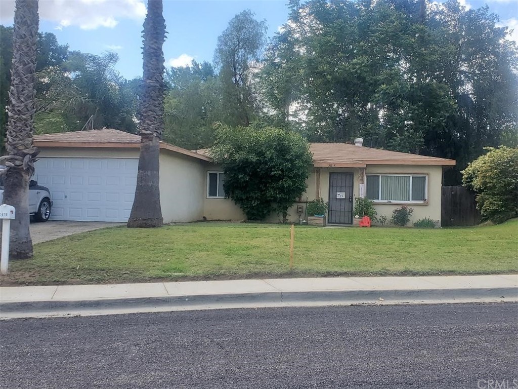 5818 Norman Way Riverside, CA 92504 - Photo 1 of 1 a view of a house with a yard and large trees