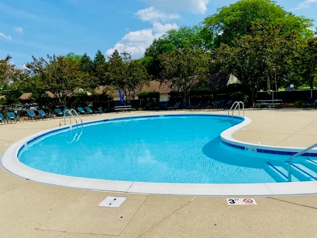 a view of a swimming pool with an outdoor space and seating area