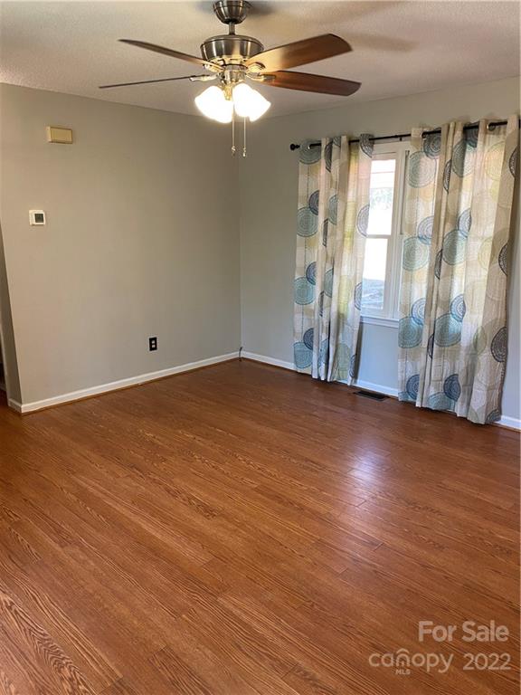 3428 Pinckney Road Chester, SC 29706 - Photo 4 of 20 an empty room with wooden floor fan and window
