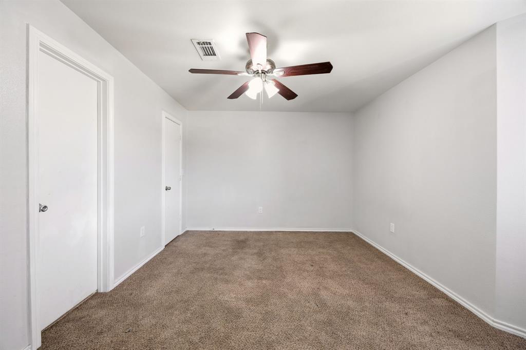 9837 Walnut Street, Unit S203 Dallas, TX 75243 - Photo 14 of 26 The room features neutral-toned carpet, light gray walls, and white trim