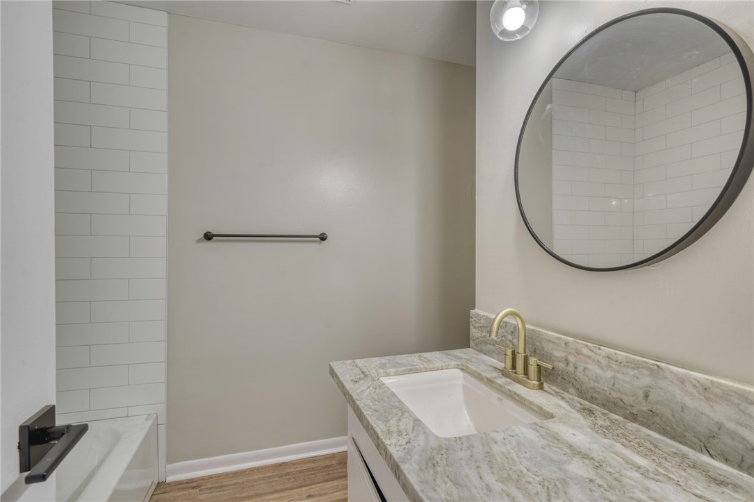3911 Olive Street, Unit A Bryan, TX 77801 - Photo 8 of 12 a bathroom with a sink and a mirror