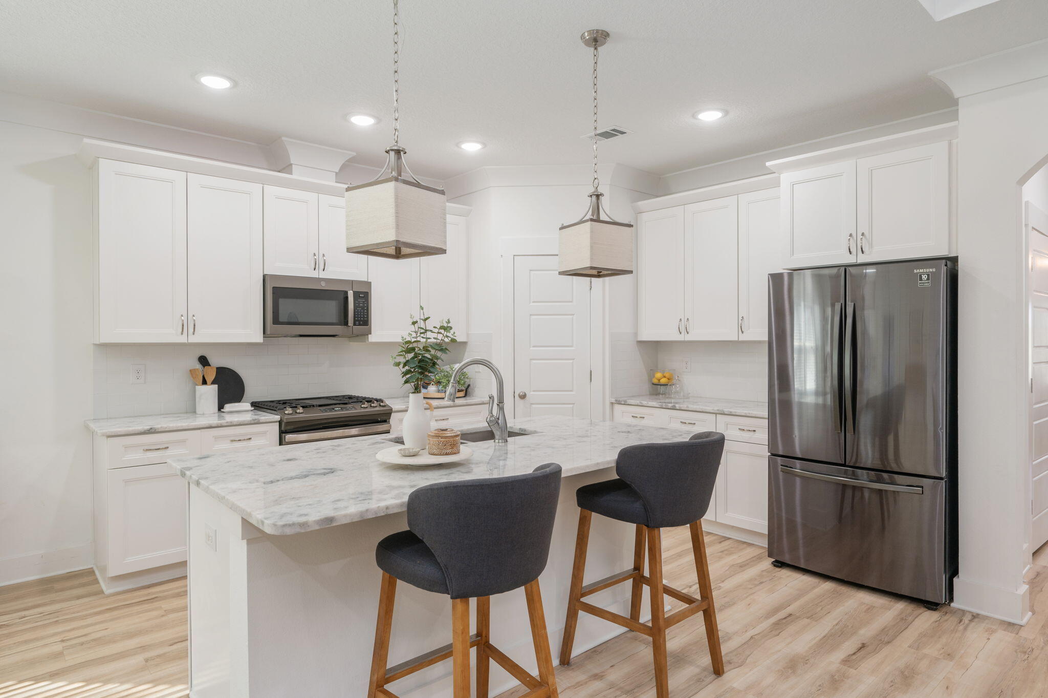 667 Red Fern Road Crestview, FL 32536 - Photo 11 of 42 a kitchen with stainless steel appliances kitchen island a refrigerator a stove a sink and a microwave