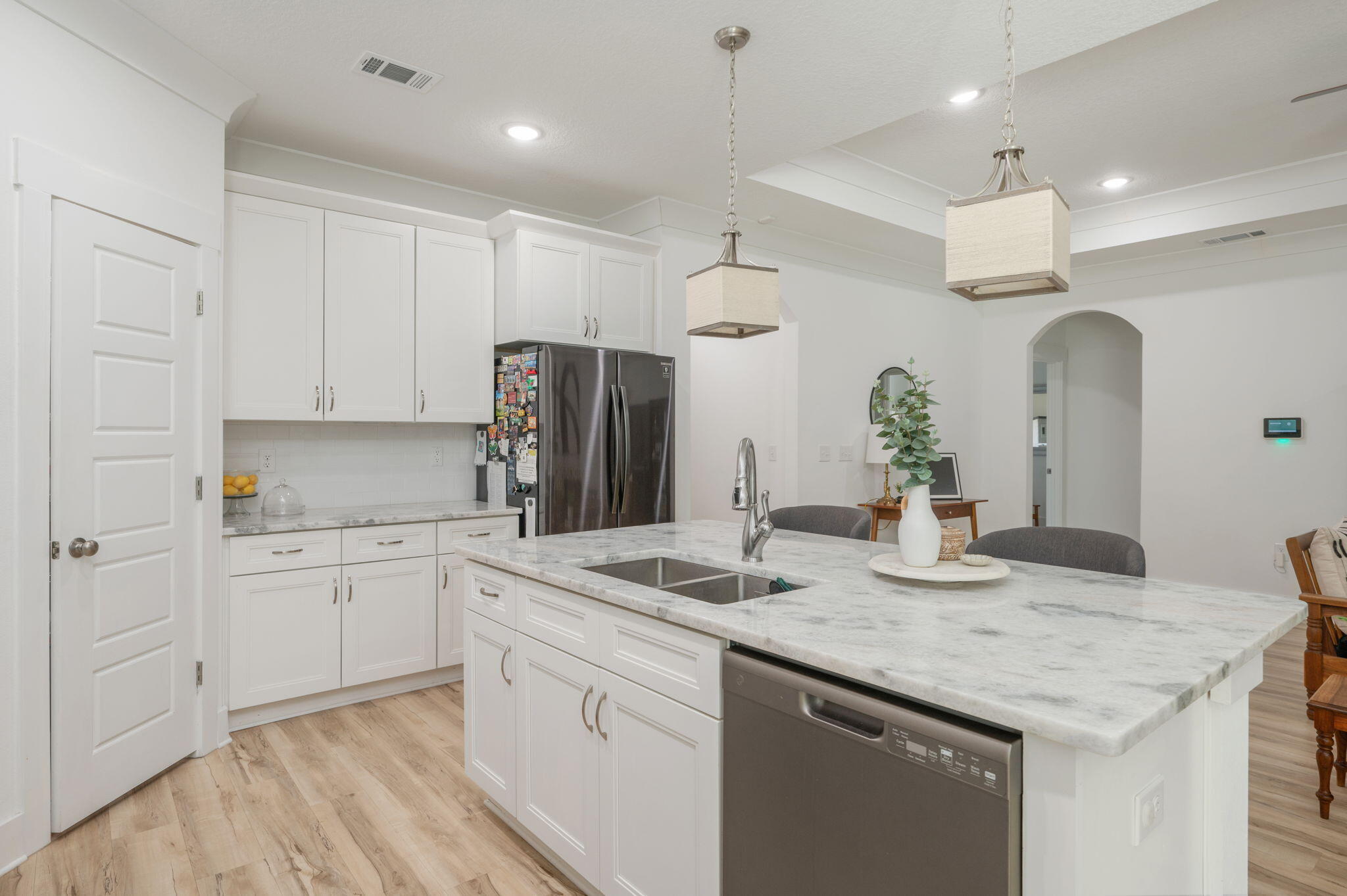 667 Red Fern Road Crestview, FL 32536 - Photo 13 of 42 a kitchen with granite countertop kitchen island white cabinets and refrigerator