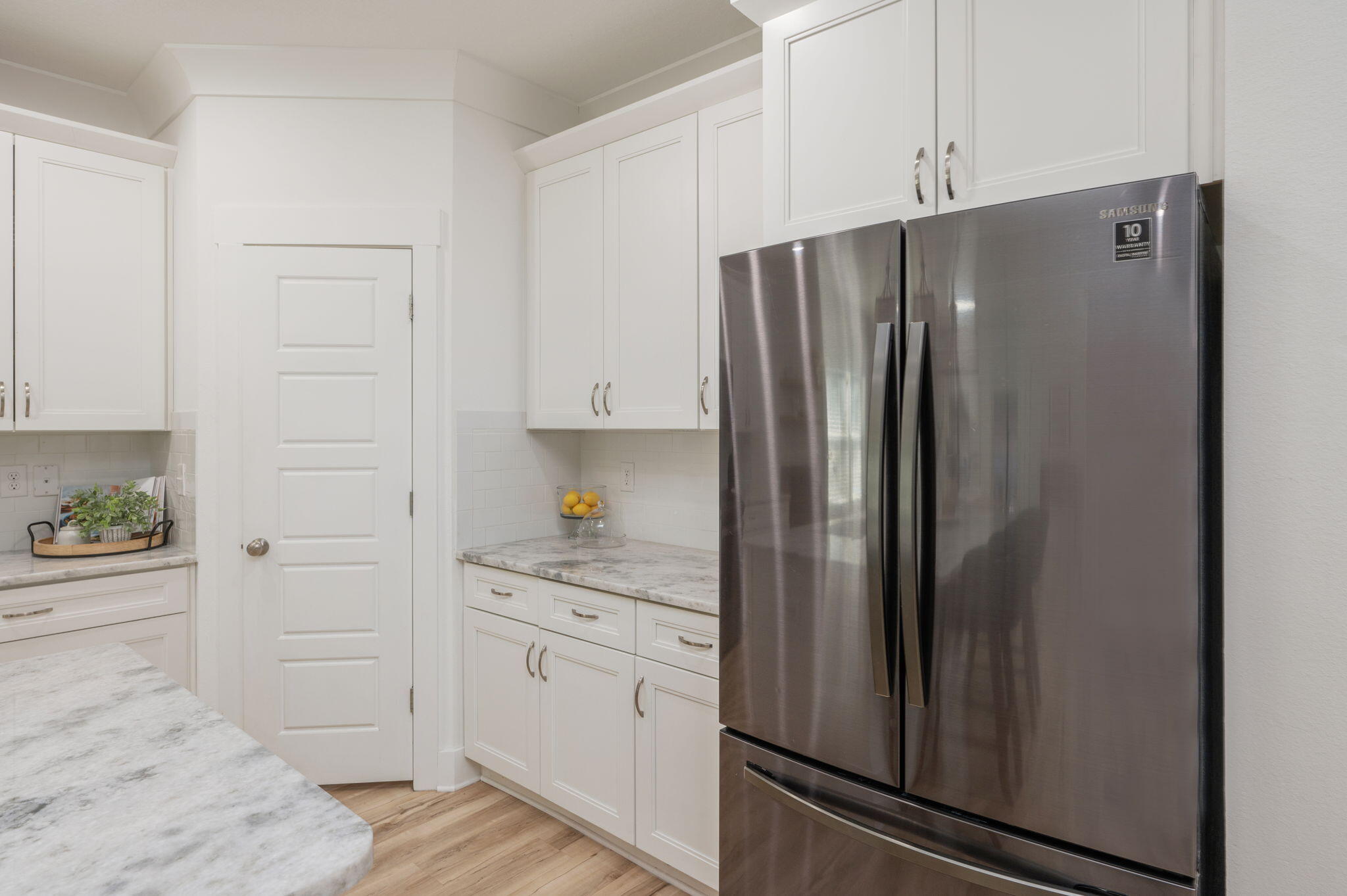 667 Red Fern Road Crestview, FL 32536 - Photo 14 of 42 a kitchen with a refrigerator and cabinets